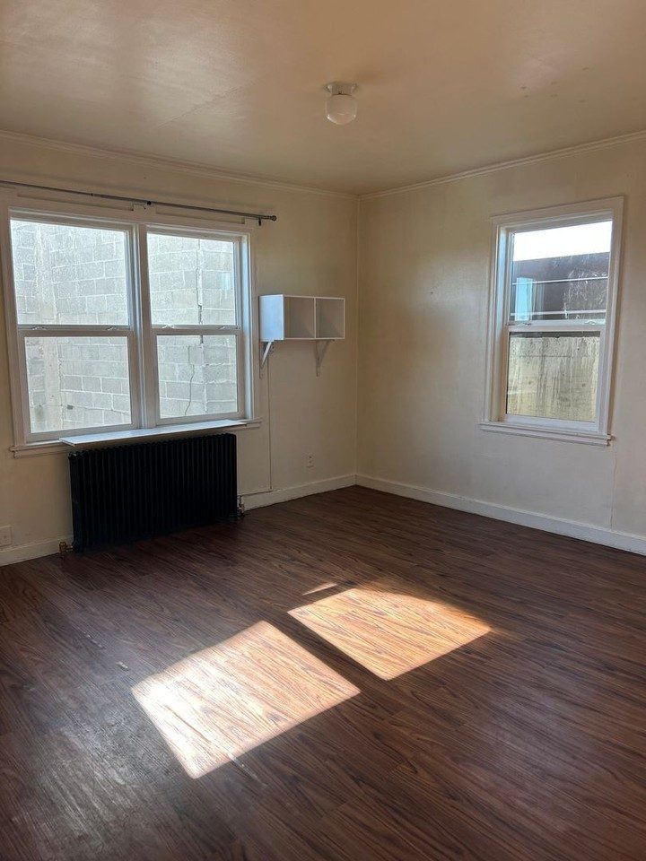 Sunlit room with wood floors at The Nest